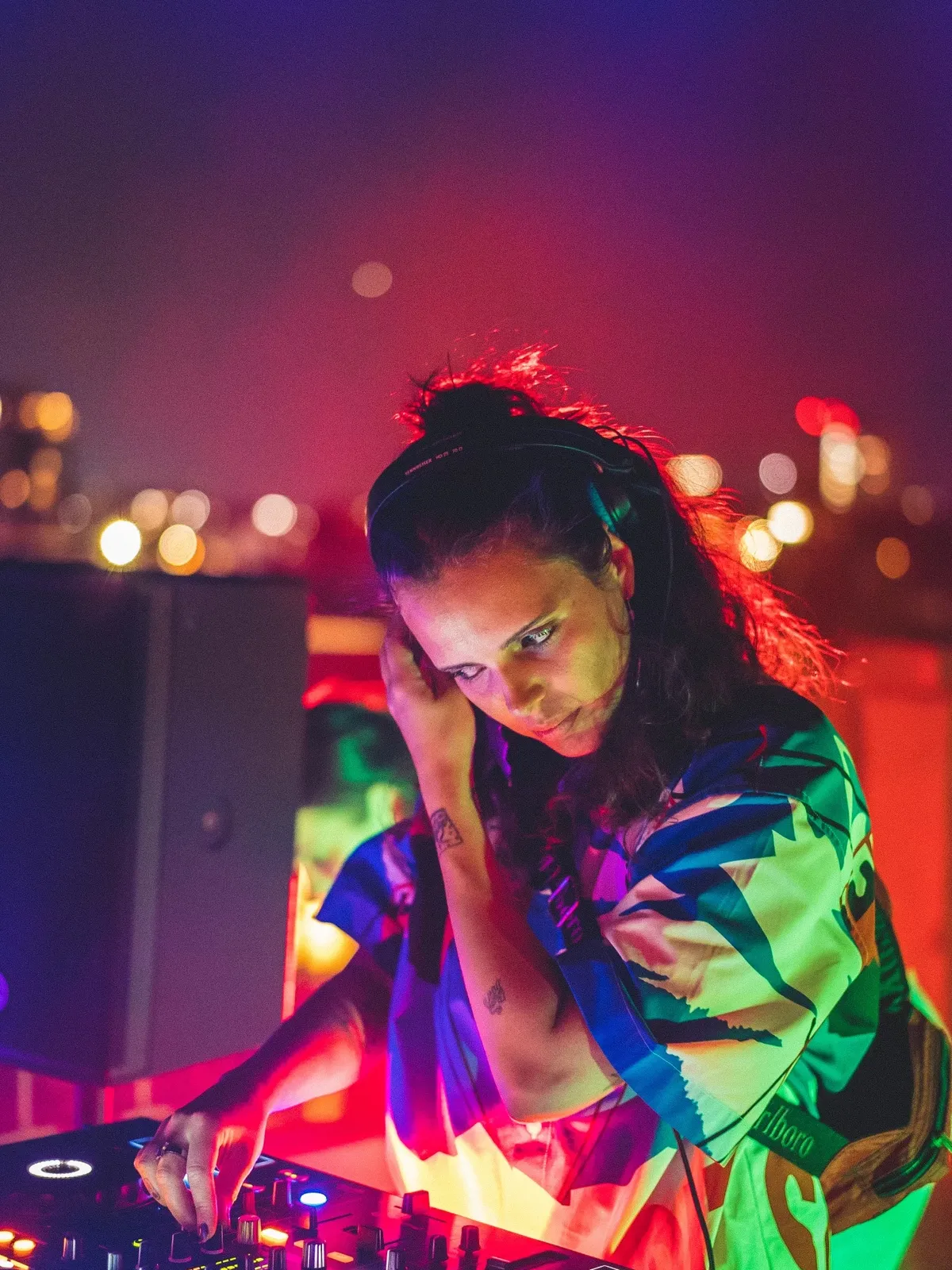 Dionne DJing under colorful lights